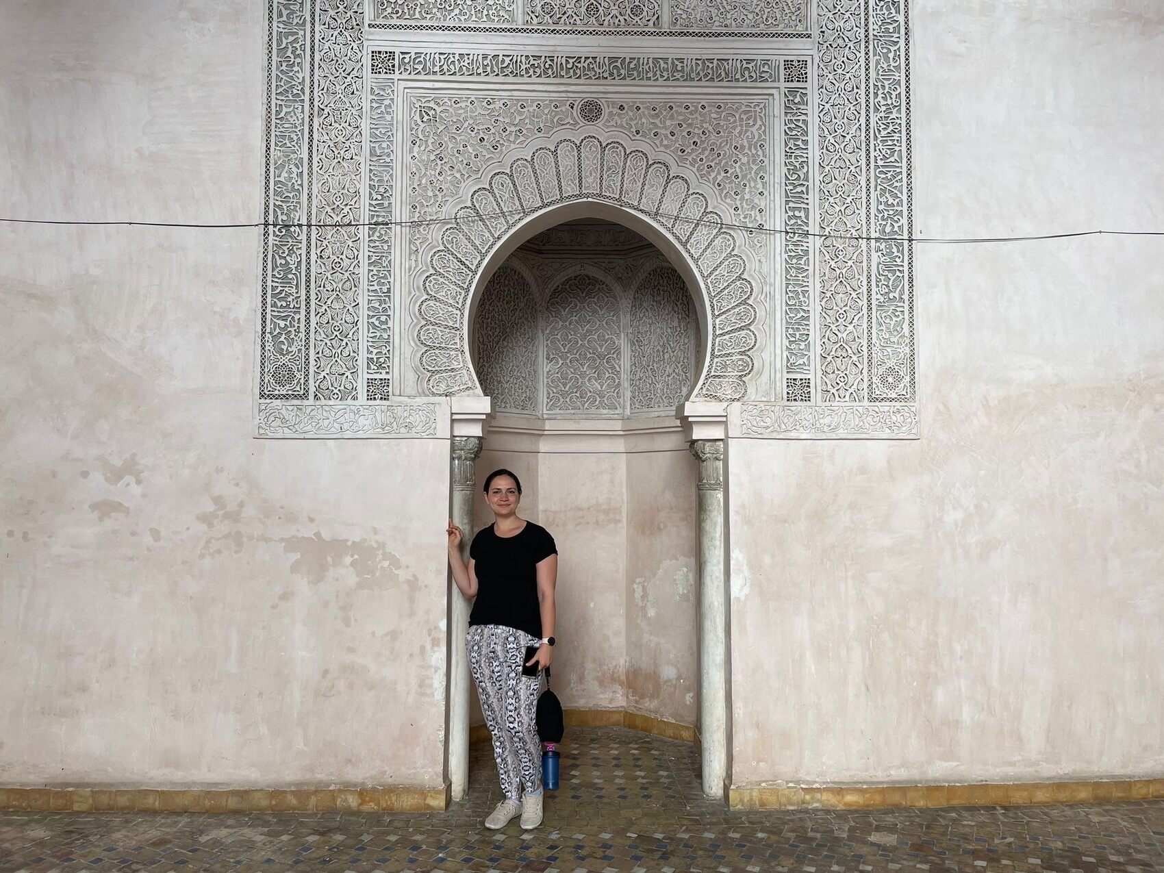 Lydia standing in front of a tiled archway in Fes